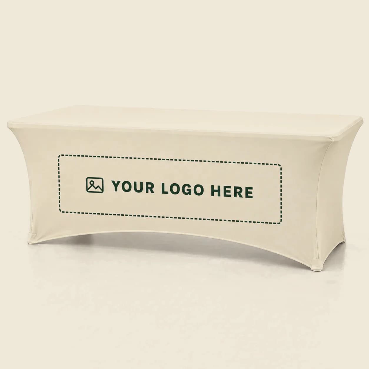 Ivory stretch table cover with hourglass sides, green YOUR LOGO HERE lettering and a dotted rectangular print area
